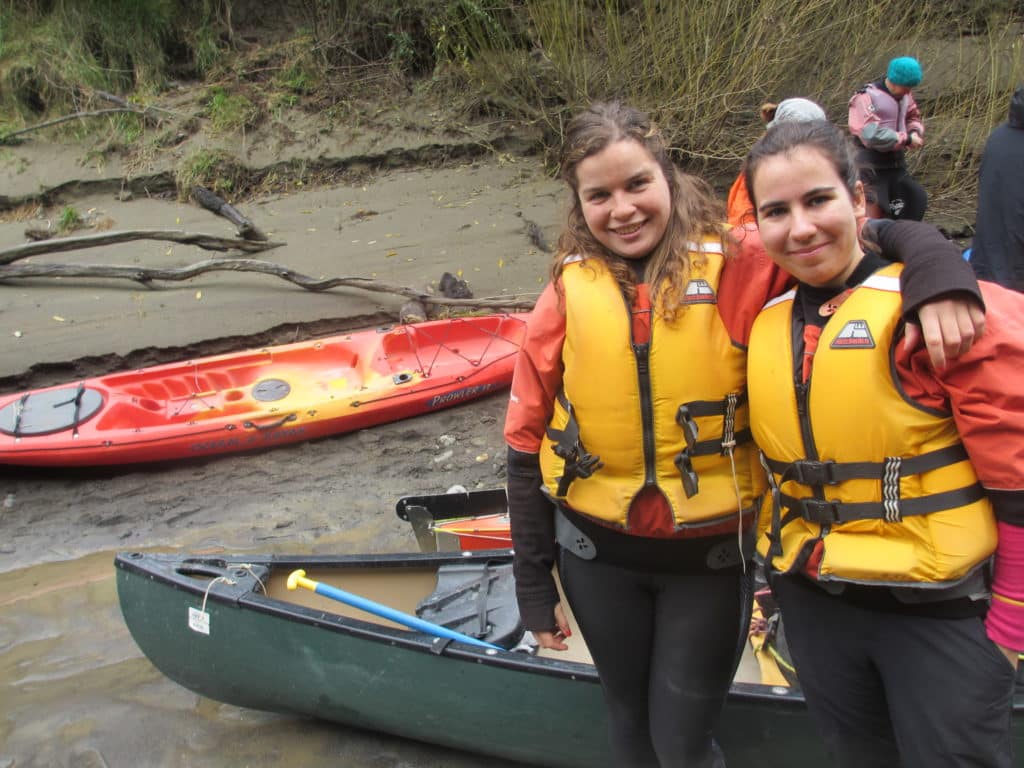 Myself and my friend Able at the side of a river in New Zealand on a multi-day canoe trip.